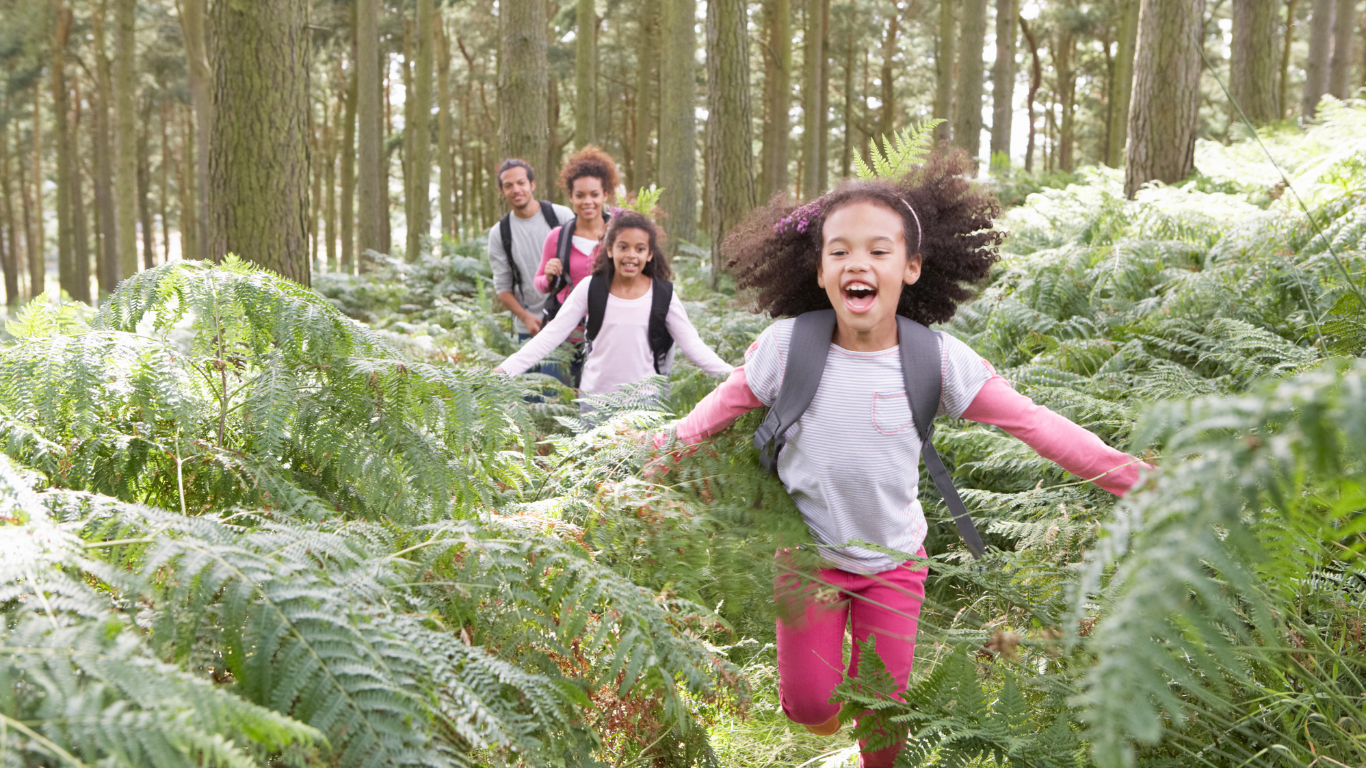 family hiking through lush forest