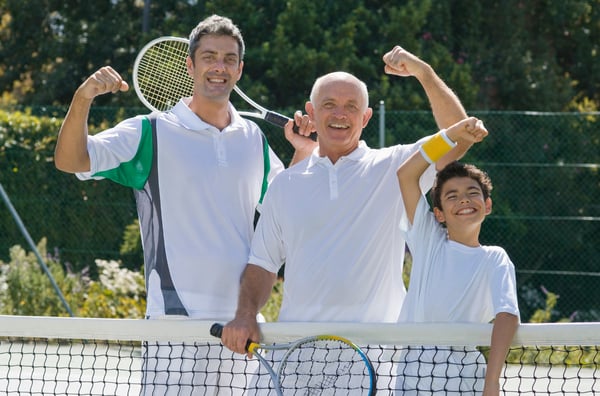 Grandfather, father, and son all on tennis court together.