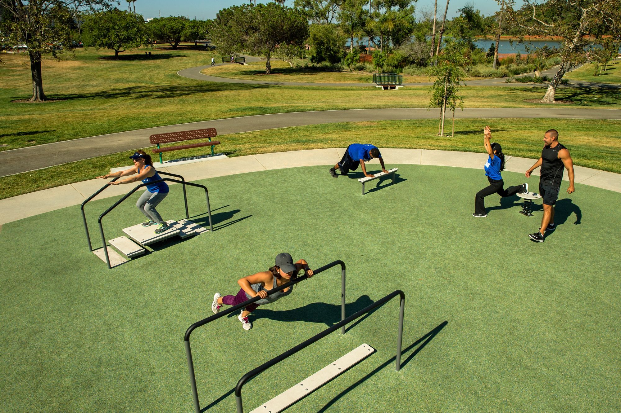 Adults working out on fitness equipment at Keiser Permanente Park
