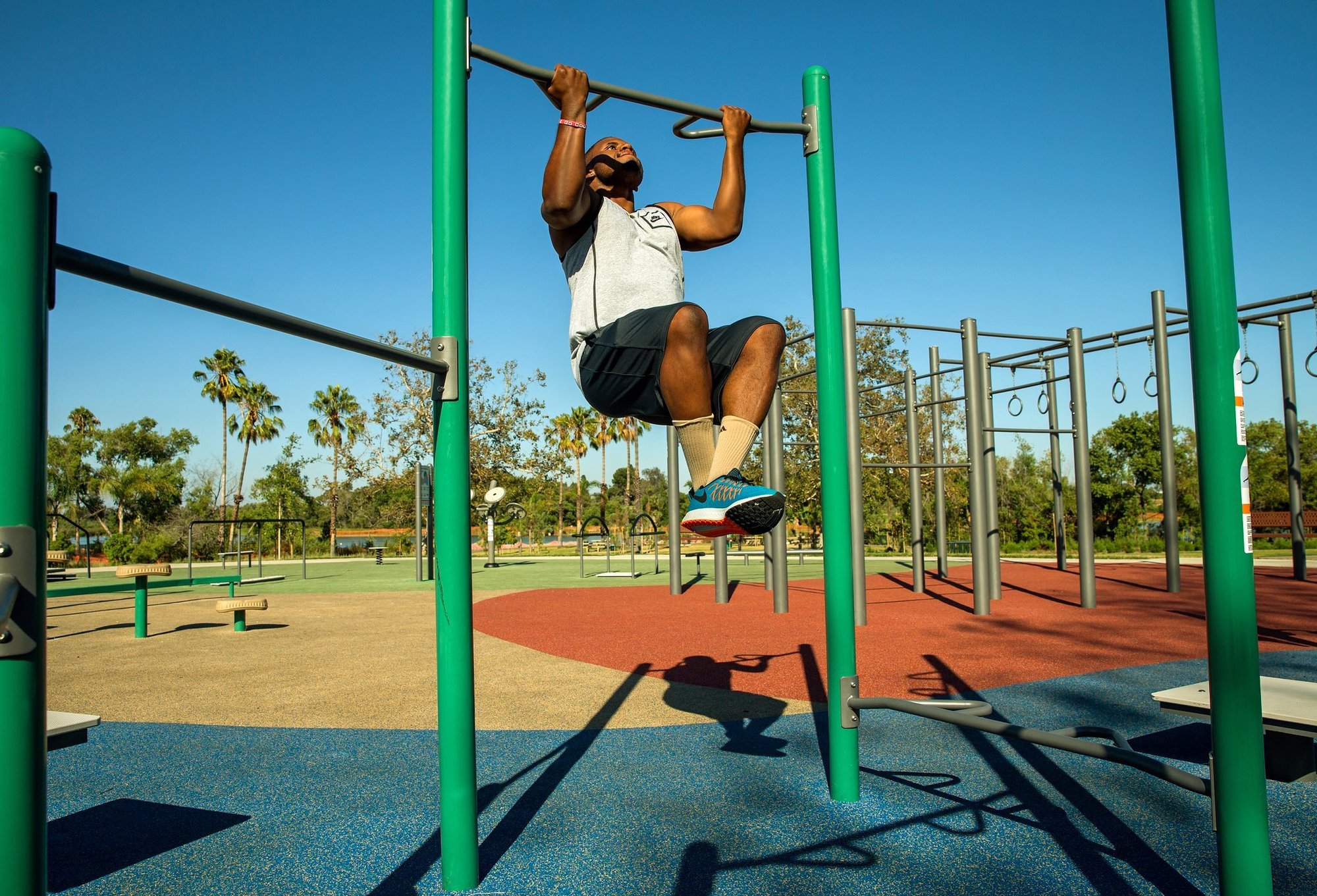 Man doing pull-up on outdoor fitness bar Man doing pull-up on outdoor fitness bar