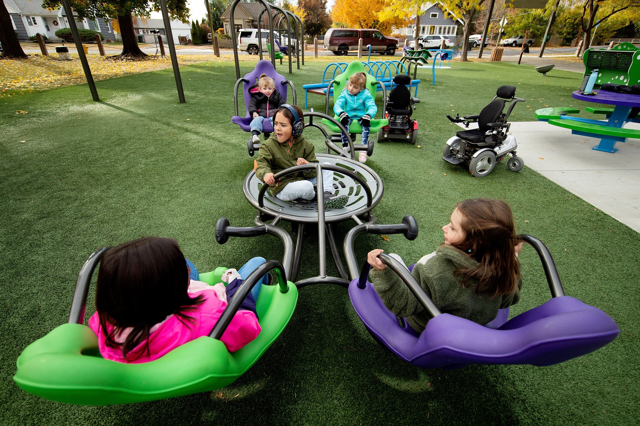 Kids who use wheelchairs playing on IMPACT Parks project playground