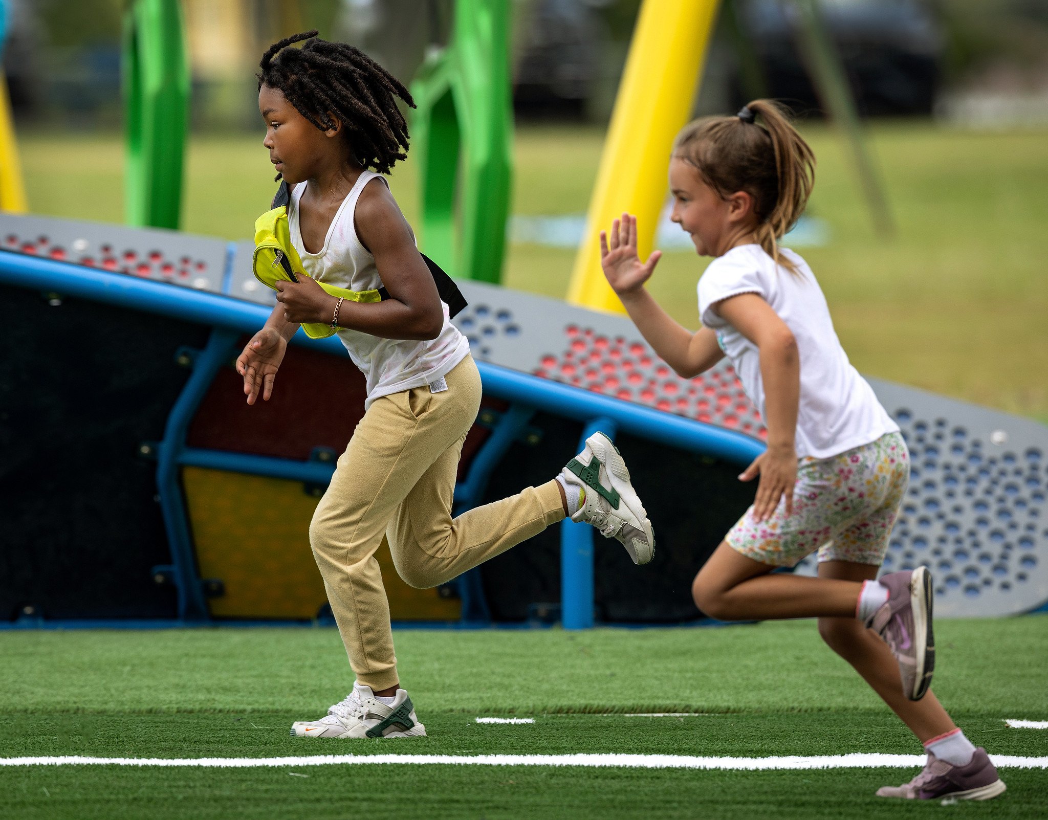 Children racing on IMPACT Parks playground