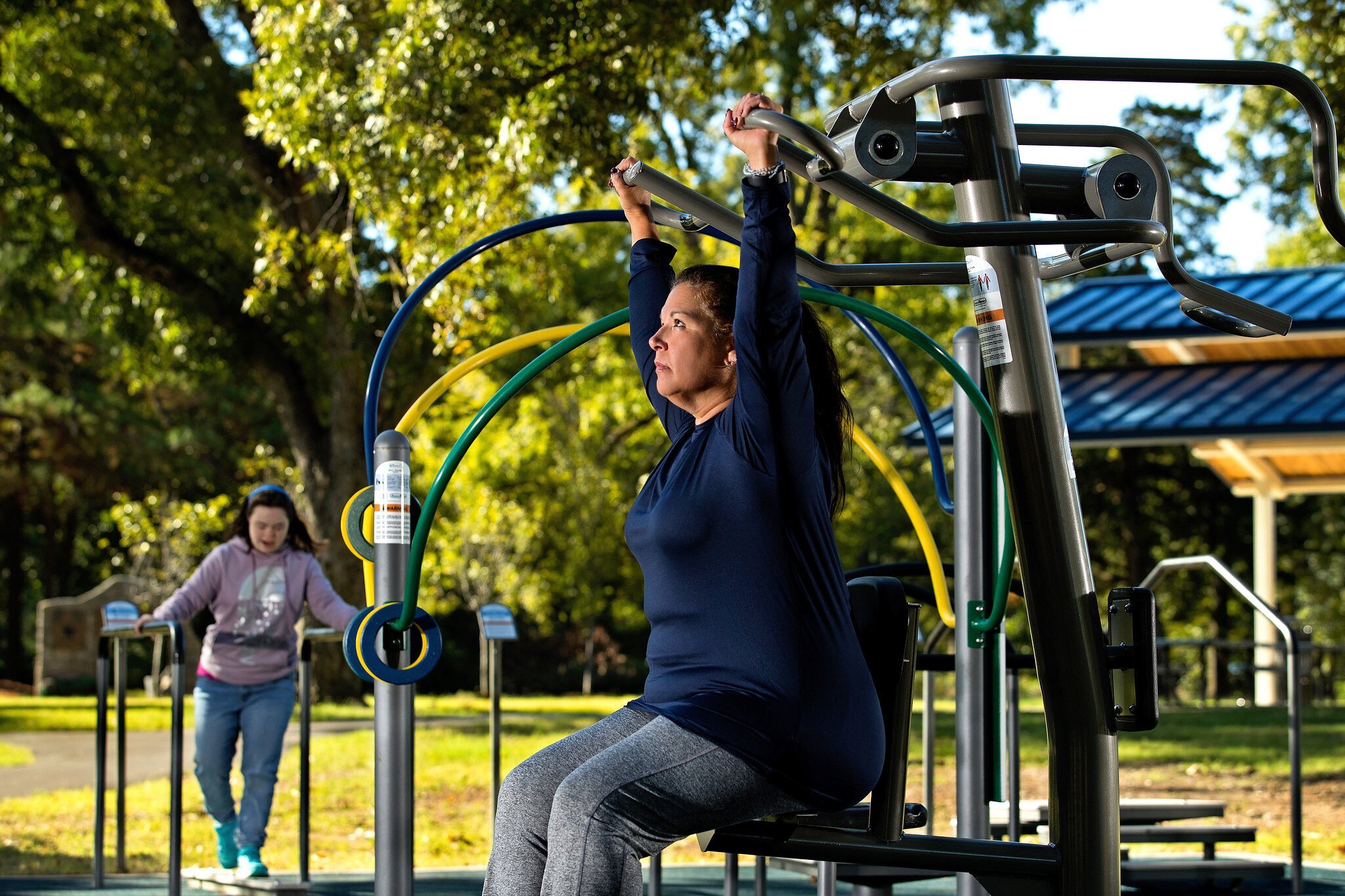 Woman and girl working out at David Carnes park by IMPACT Parks