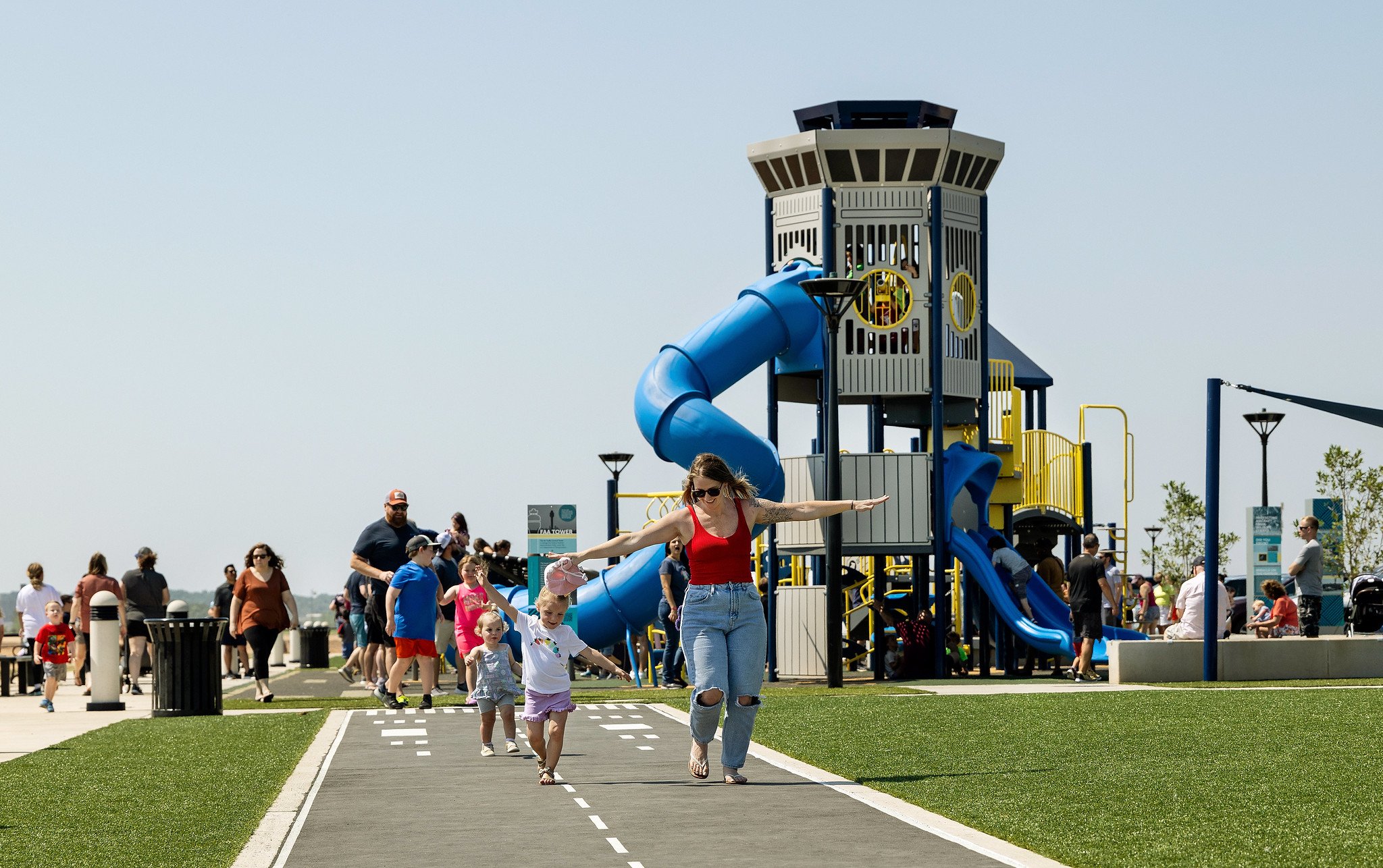 Mother and children getting exercise at IMPACT Parks playground