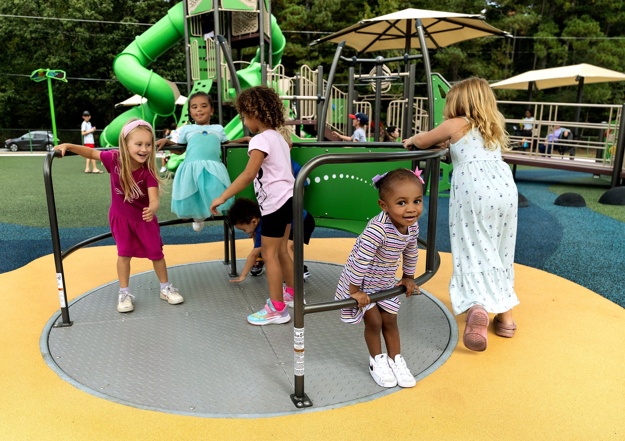 Group of girls pushing each other on Inclusive Whirl