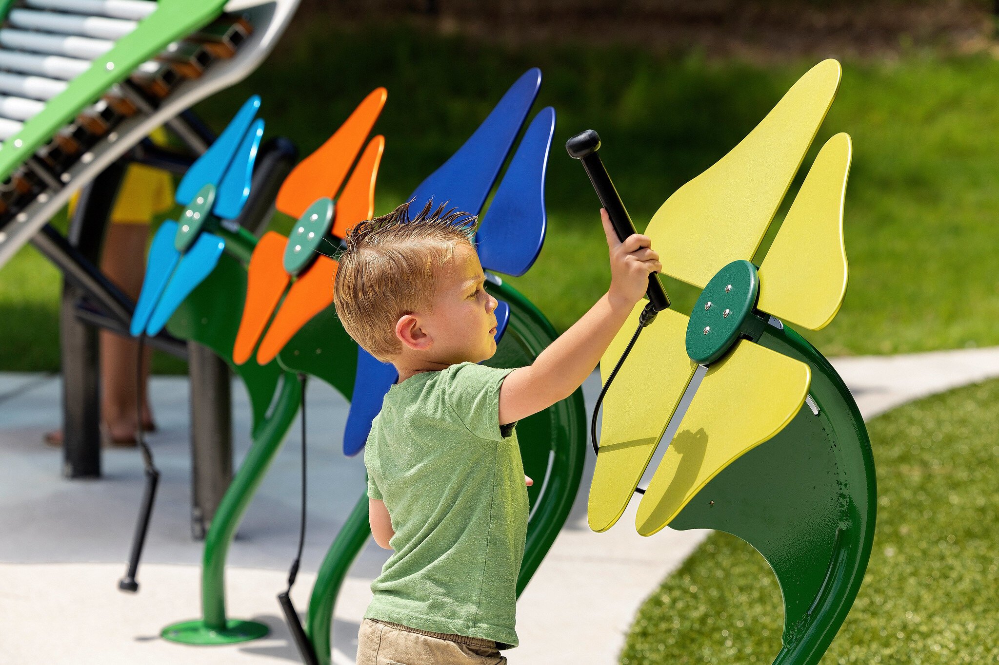 Little boy playing with instruments in park - Freenotes Harmony Park