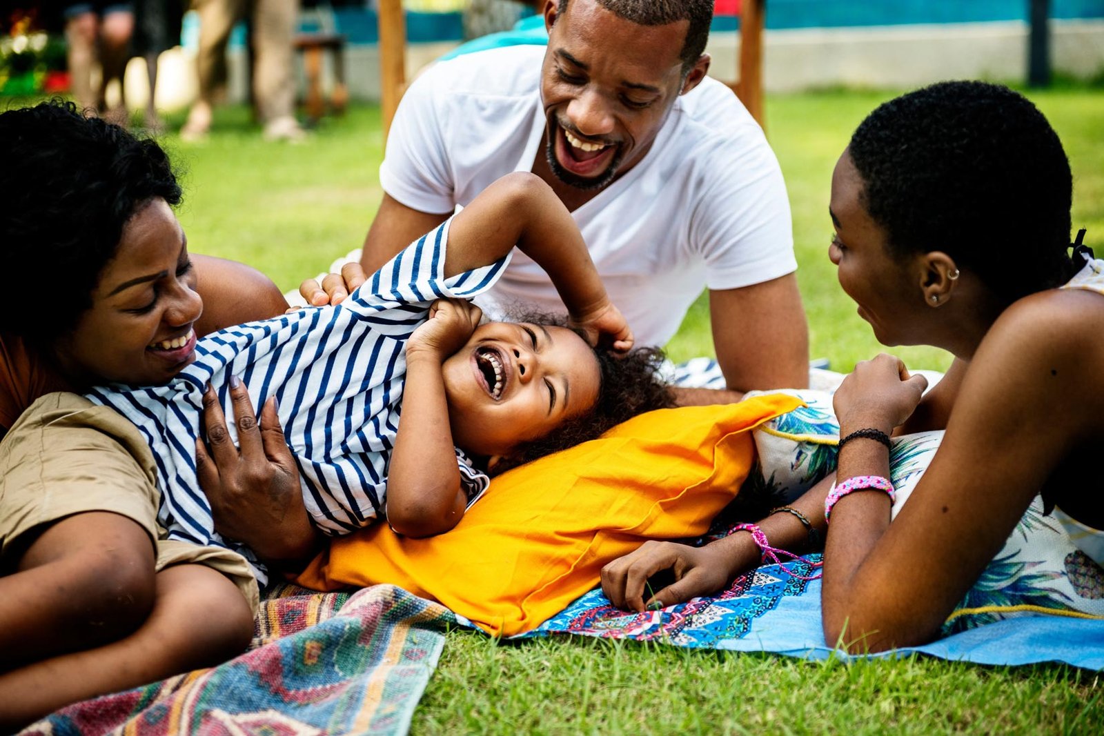 Family Laying in Grass at Park