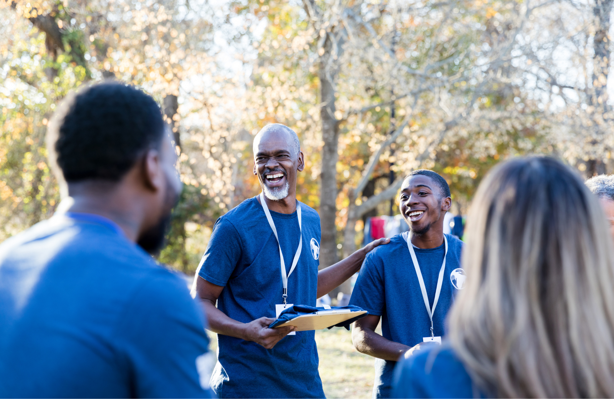 Employees outdoors in volunteer shirts