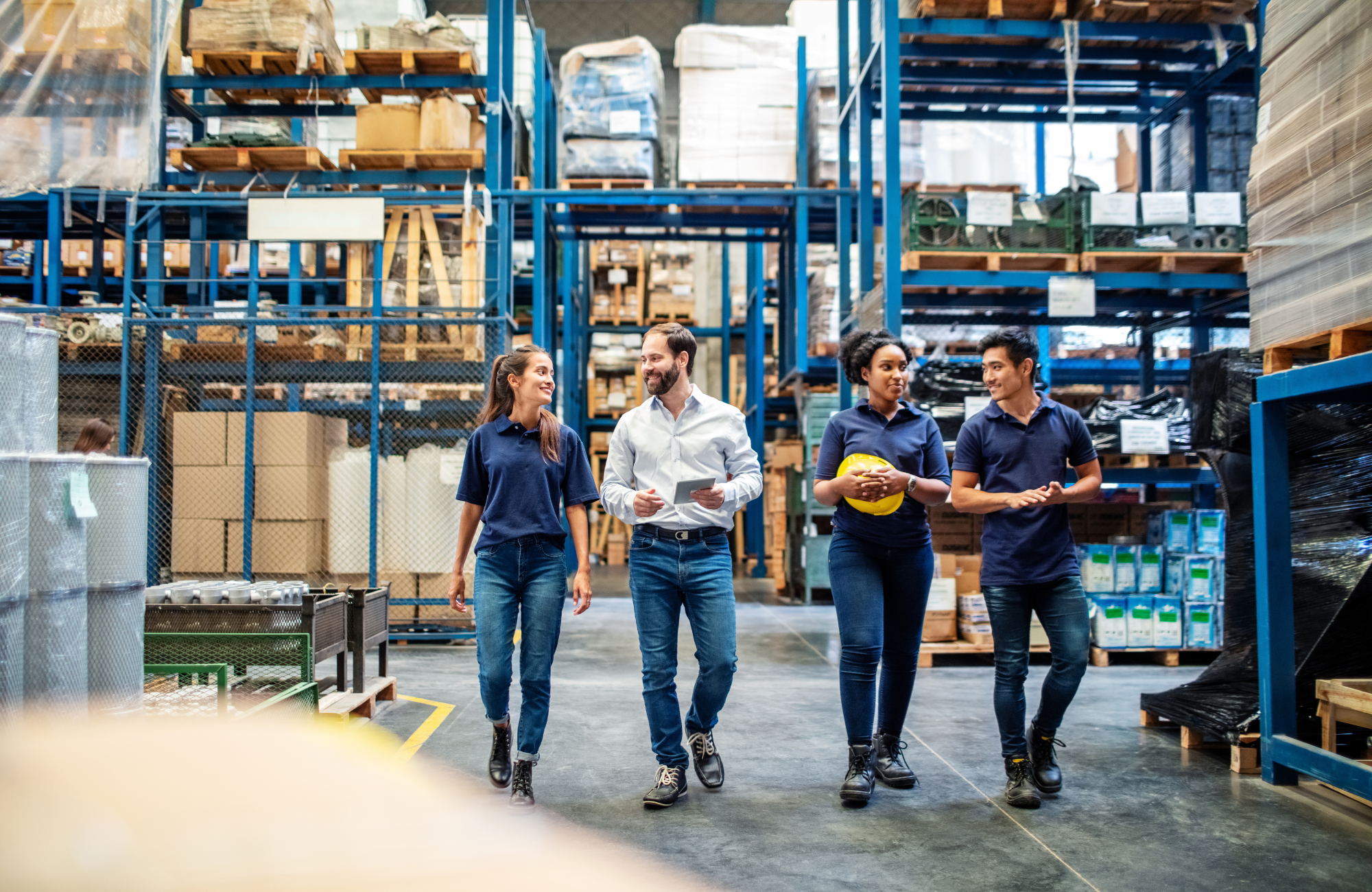Employees at a warehouse smiling and walking