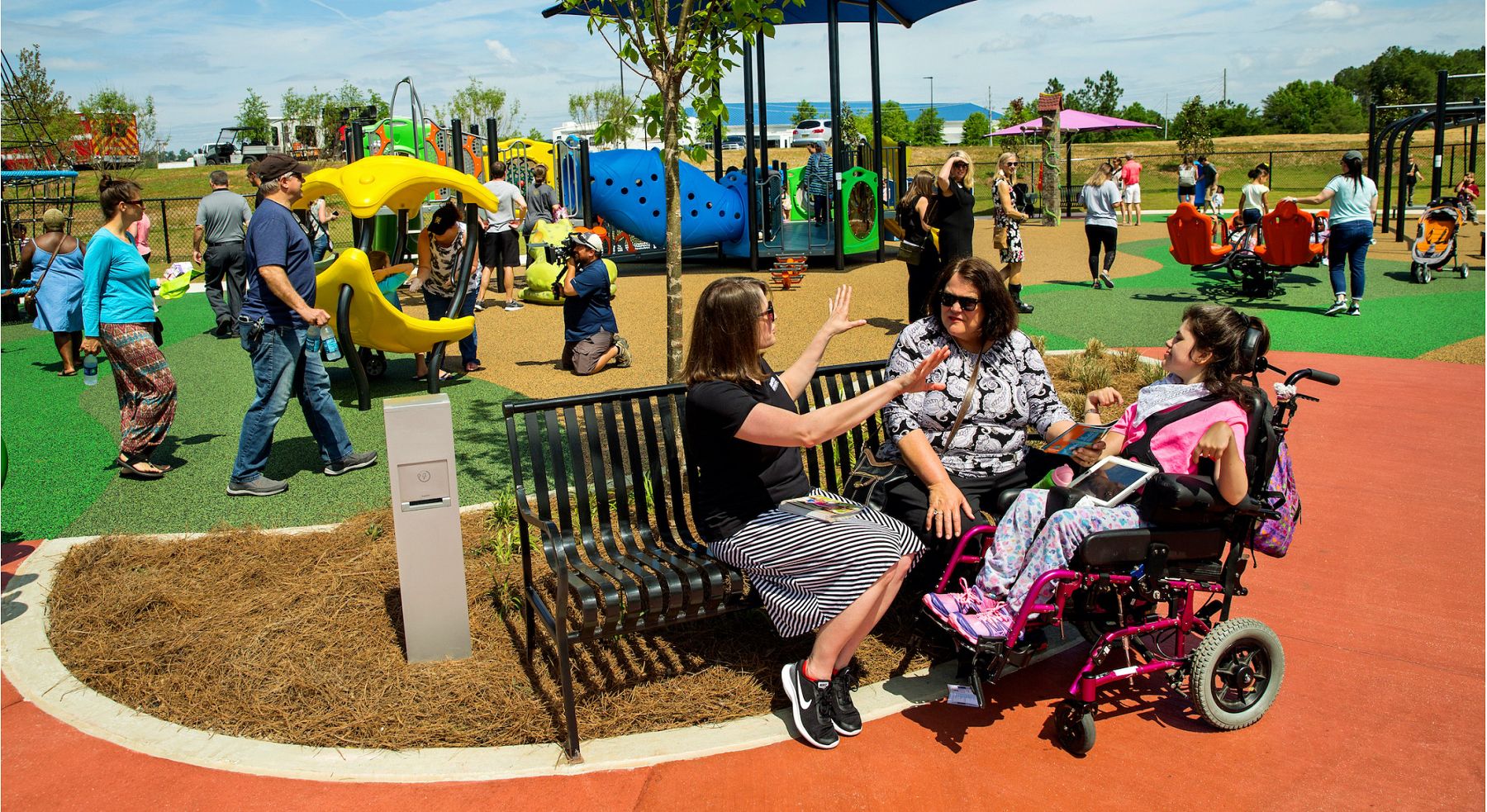 Community gathering on IMPACT Parks playground