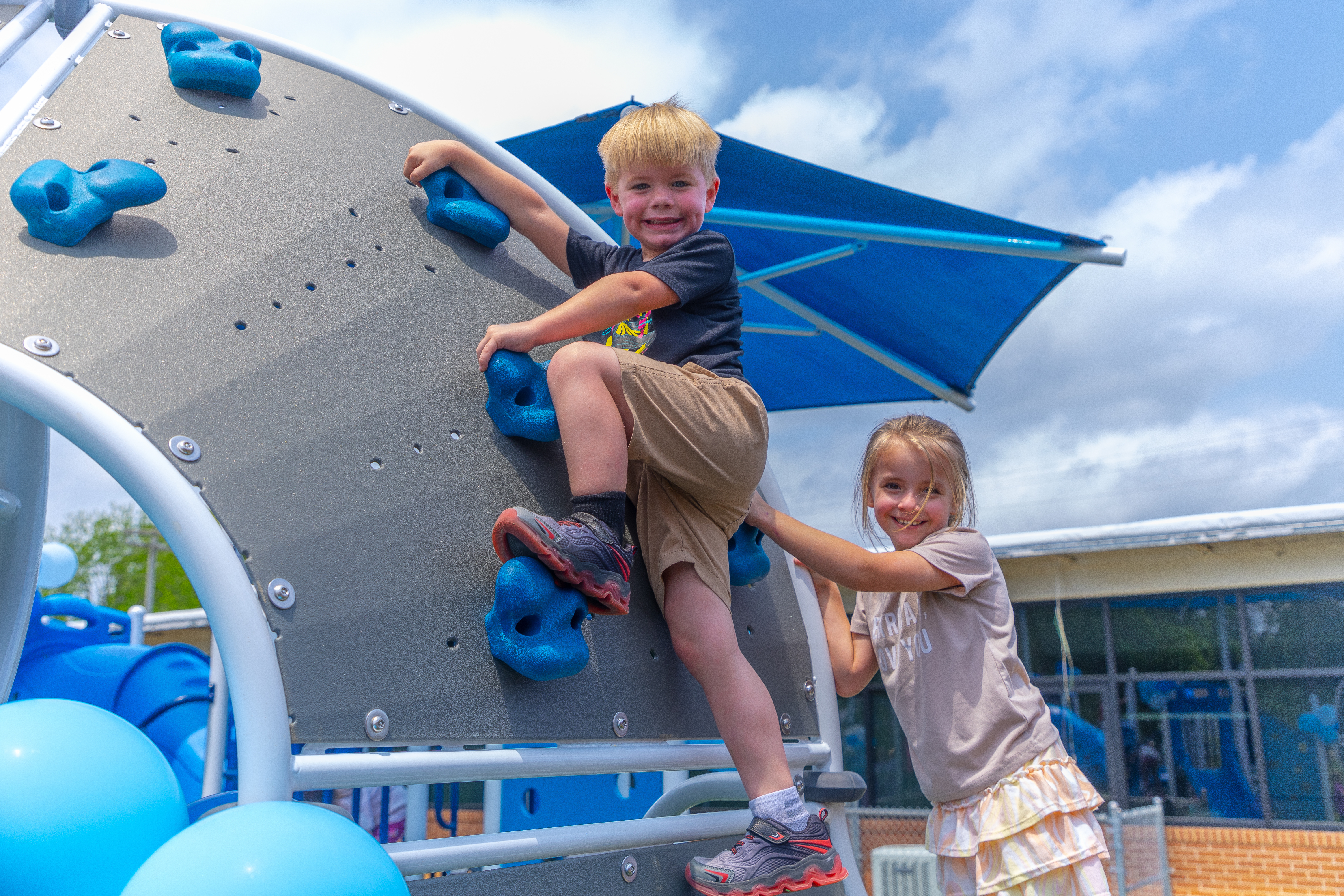Boy and Girl on rock wall at MS Healthy School