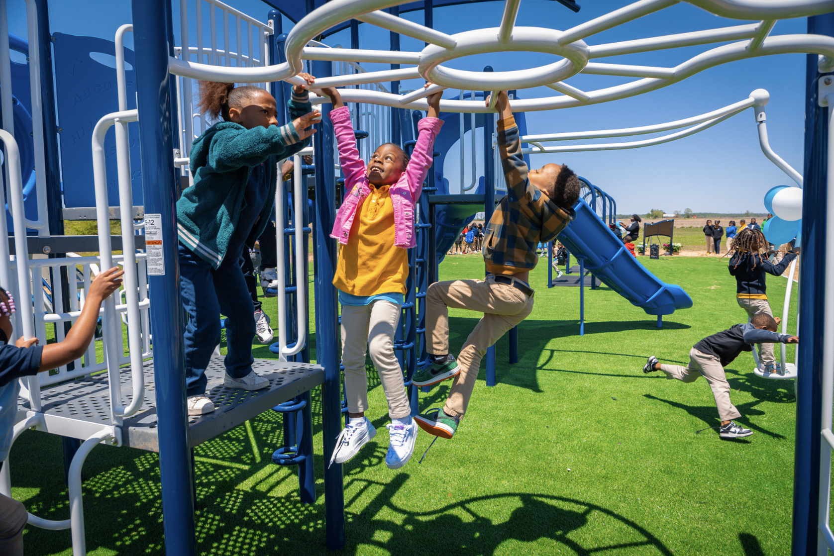 Children playing on BCBS playground by IMPACT Parks