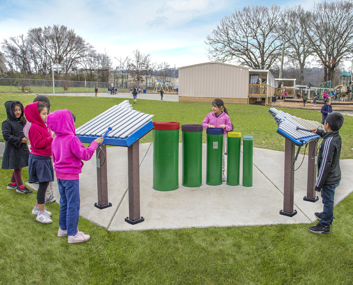 Children playing with musical instruments in a park - Freenotes Harmony Park