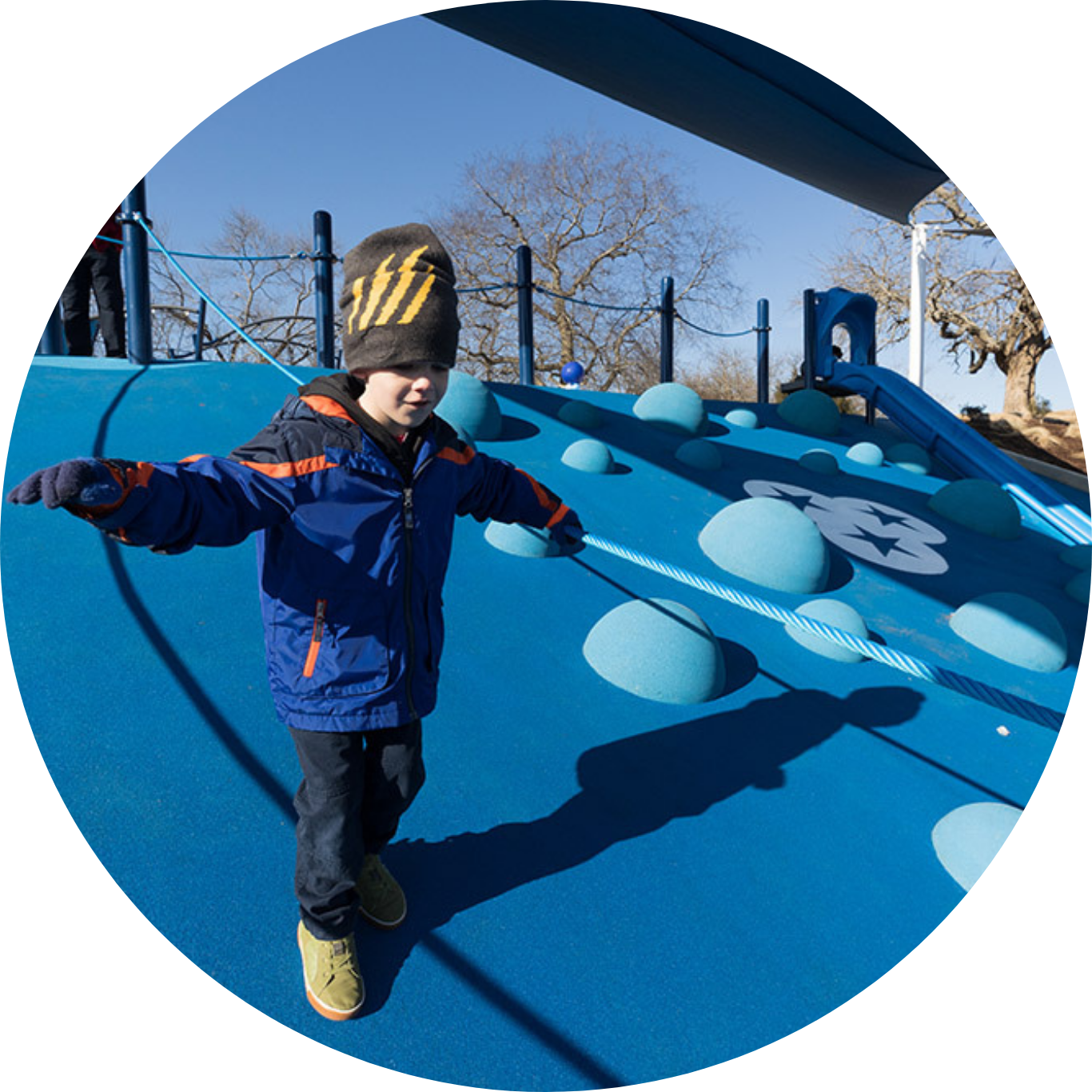 Child running down hill at Northwest Family YMCA