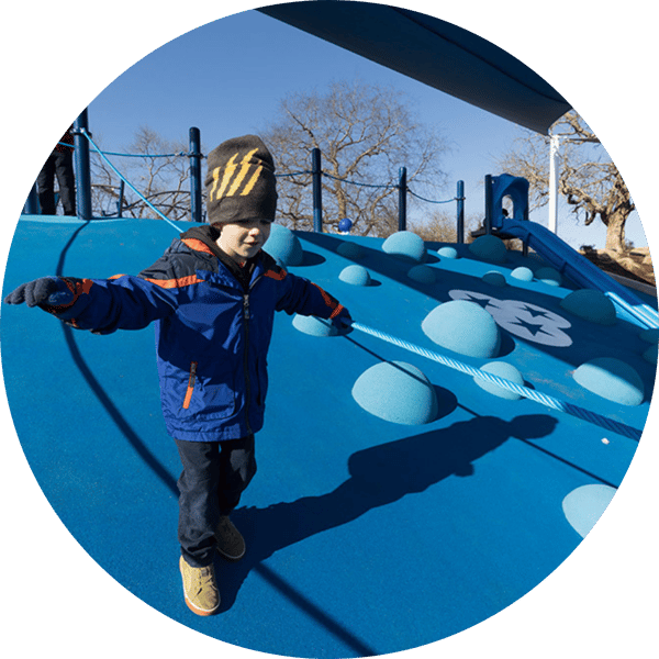 Child running down hill at Northwest Family YMCA