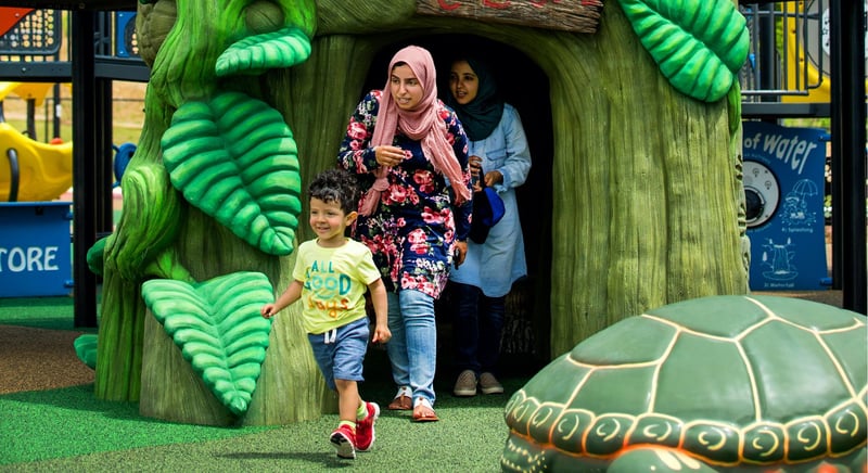 Family enjoying IMPACT Parks playground