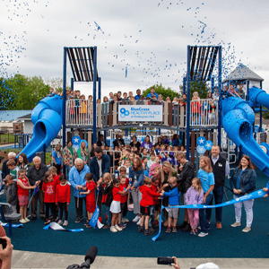 BlueCross Healthy Place ribbon cutting with entire community present in front of playground