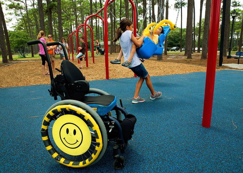 Children playing on IMPACT parks swing set