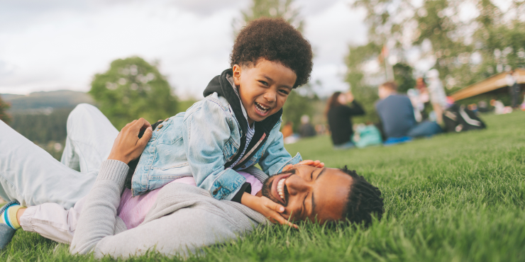 father and son in the grass